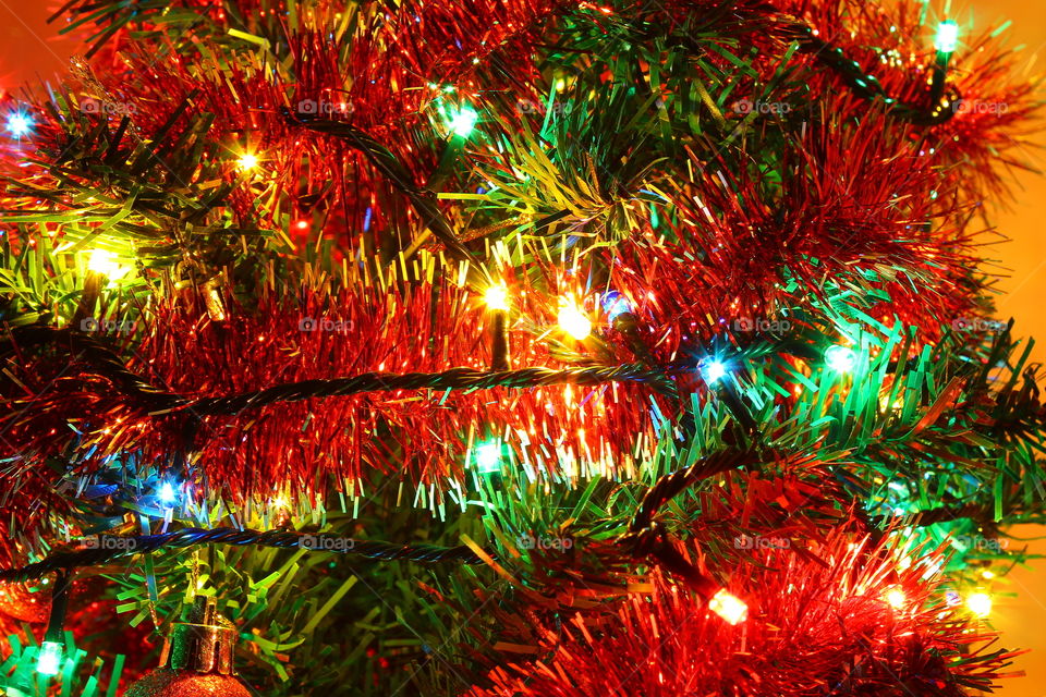 Macro shot of Christmas tree decorations and vivid lights