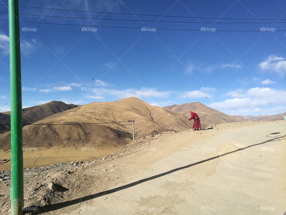 Nun staring into the Valley at Se Da Buddhist Monastery and School in Sichuan Province, China.

Se Da is currently the largest Tibetan Buddhist school in the world and not open to westerners.