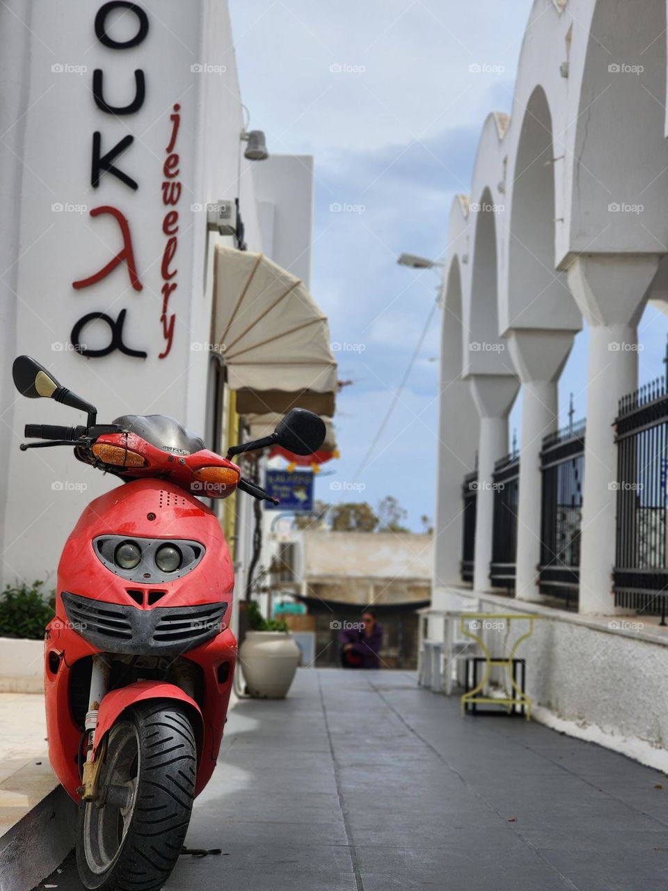 Red scooter parking in the street