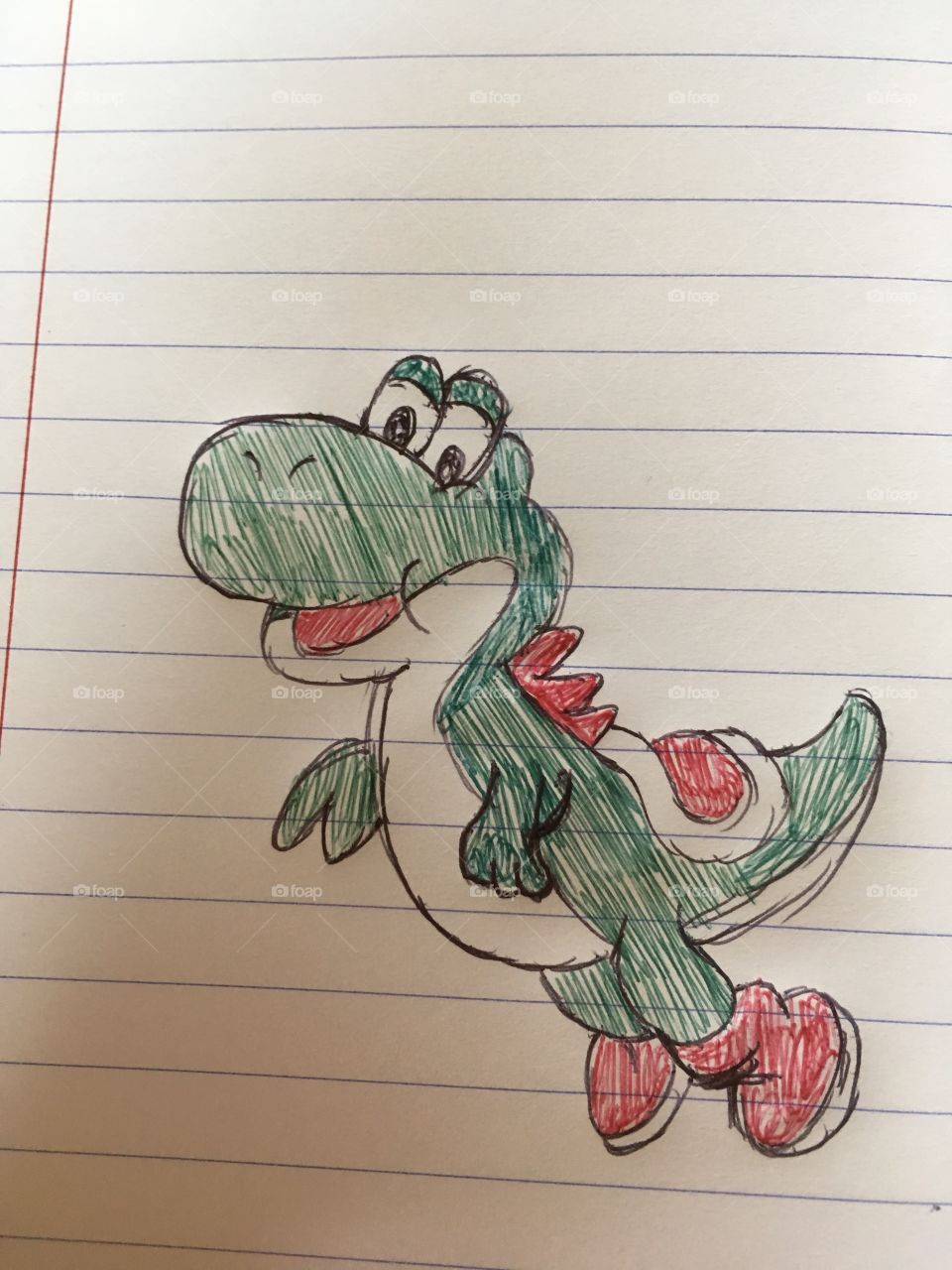 A doodle of yoshi from super mario in a copybook