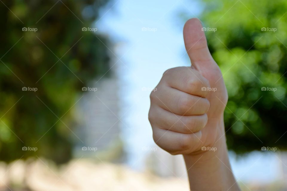 Kid thumb up at the park 
