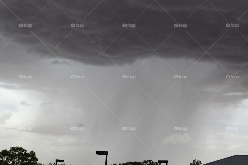 Dark gloomy rain clouds passing over