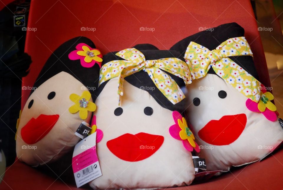 Smile!. Three pillows decorated as the faces of Italian ladies with bright red smiles 