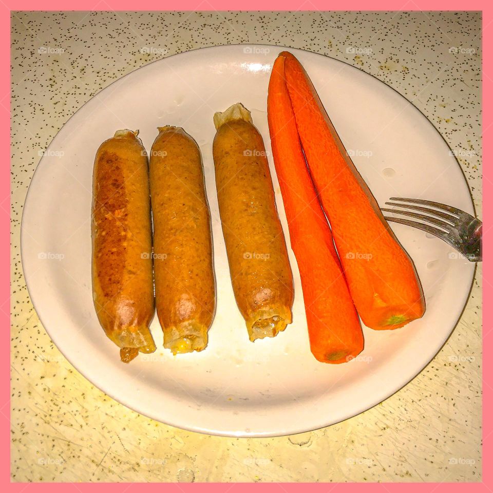 Sausages and carrots for lunch. It is a simple yet delicious meal to satisfy one’s hunger.