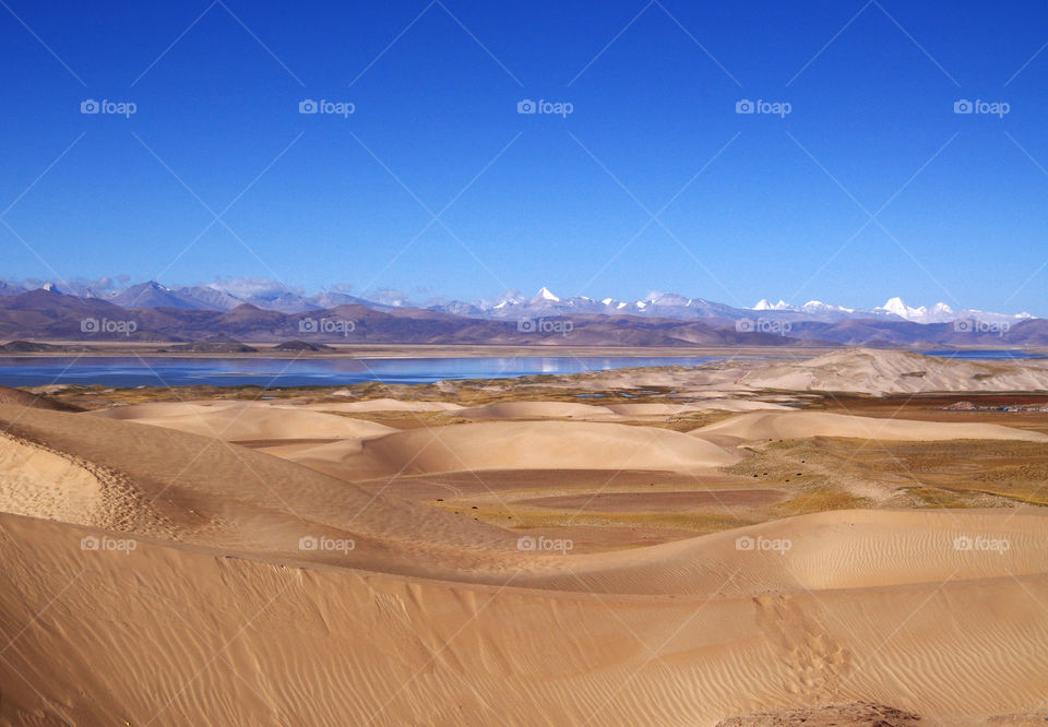 Sand dunes and Himalayas during winter