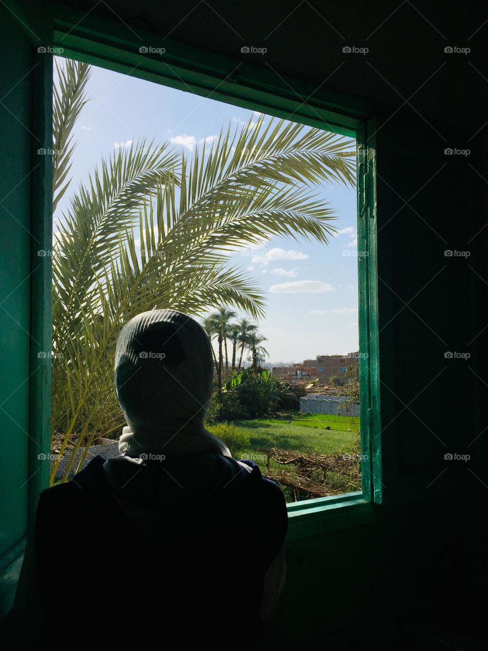 A girl is looking from a window