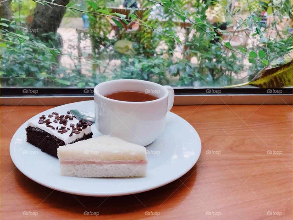 Tea with cake and sandwich