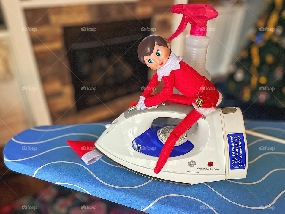 Elf on the shelf ironing hat, elf helps with household chores, doing laundry with elves, elf on the shelf helper, ironing elf hats, elf on the shelf tradition 