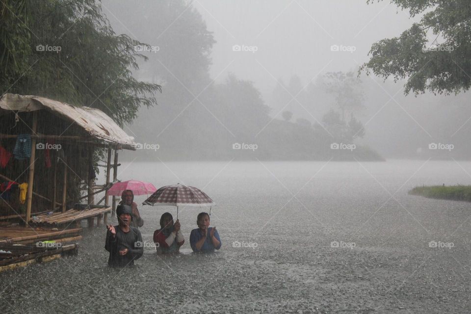 Poor family under the rain 