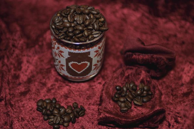 Fragrant coffee beans are scattered on a red background. Roasted coffee beans close up.