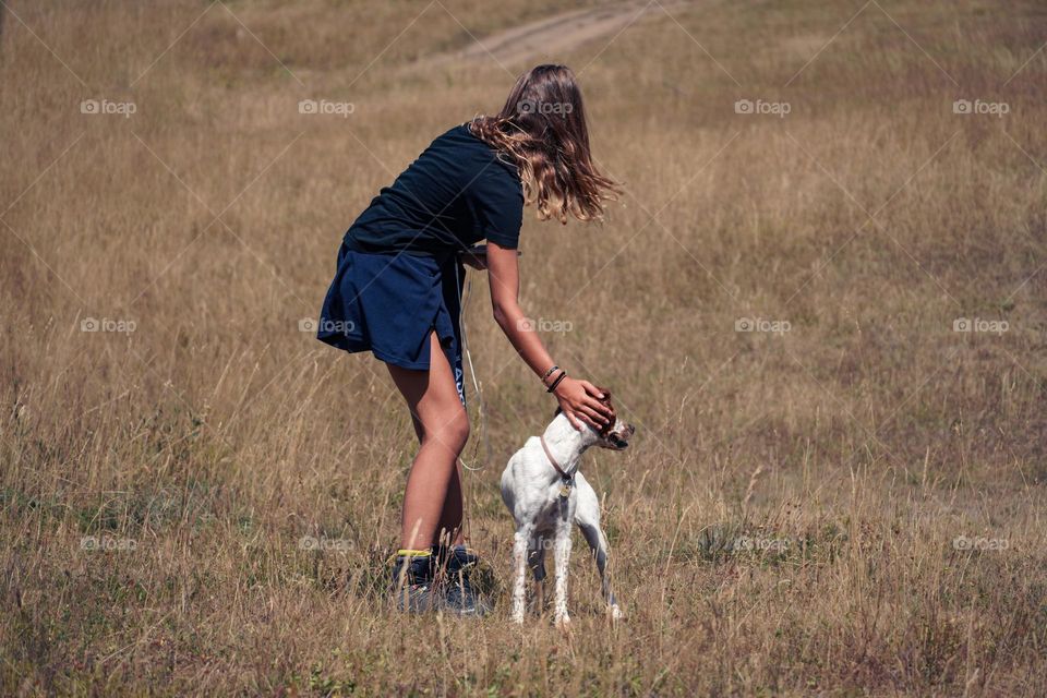 Girl is walking with a dog