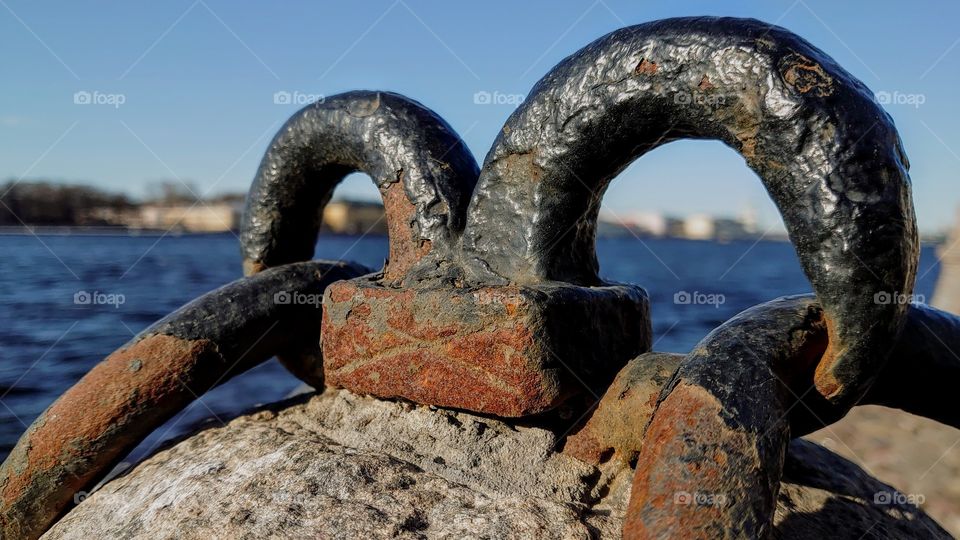 Fastening chains on a granite embankment in St. Petersburg