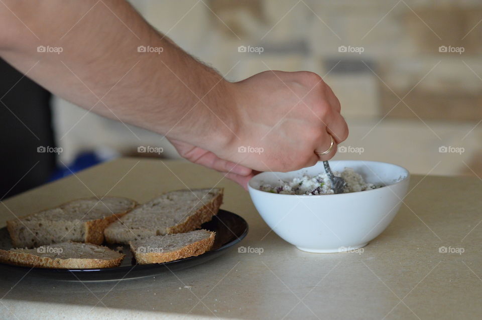 Healthy breakfast- white cottage cheese with onions, chives, salt and pepper on bread