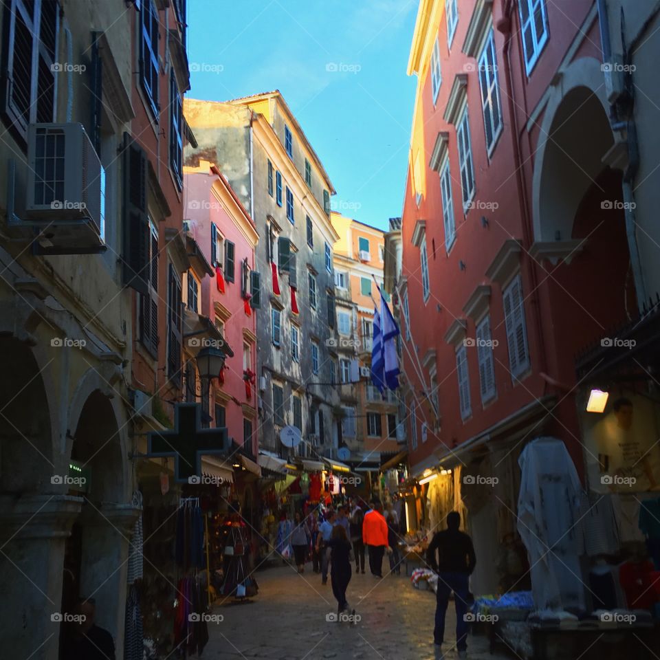 Bustling street and pastel buildings in Corfu Town, Greece