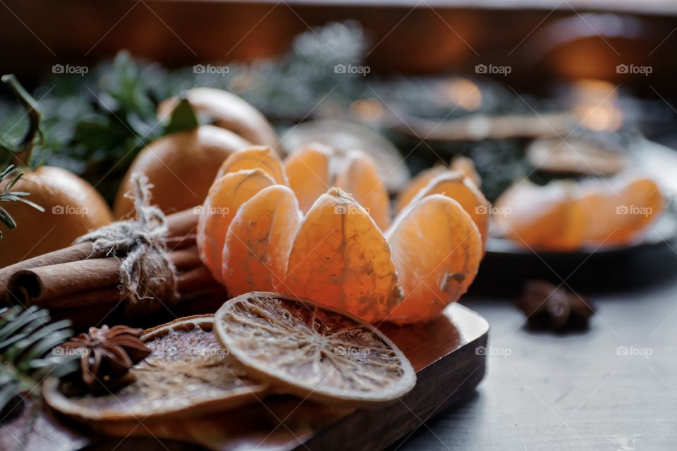 Flatlay mandarin orange cinnamon and Christmas tree branches 