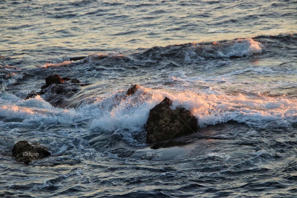 View of the wavy rocky atlantic ocean at sunrise 