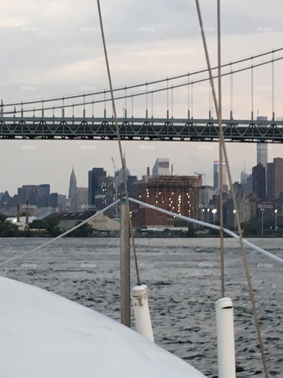 The 69th Street Bridge connecting Queens and Manhattan‘s Upper East Side at upcoming twilight time while we were traveling south by sailboat towards Newtown Creek in LIC, Queens, NY. 2017. Hypnotic Productions