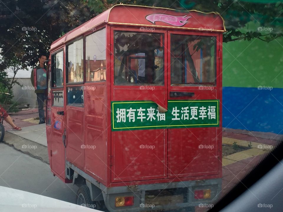 A little red car in rural countryside in China 