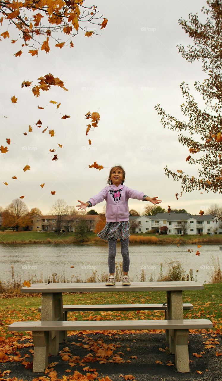 girl catching the falling leaves