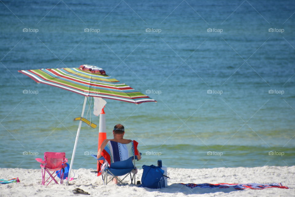 Rear view of a man resting on beach