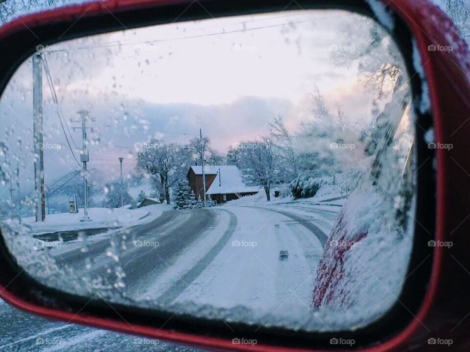 Looking out the side mirror rearview into a gorgeous sunrise after the snow storm breaks! 