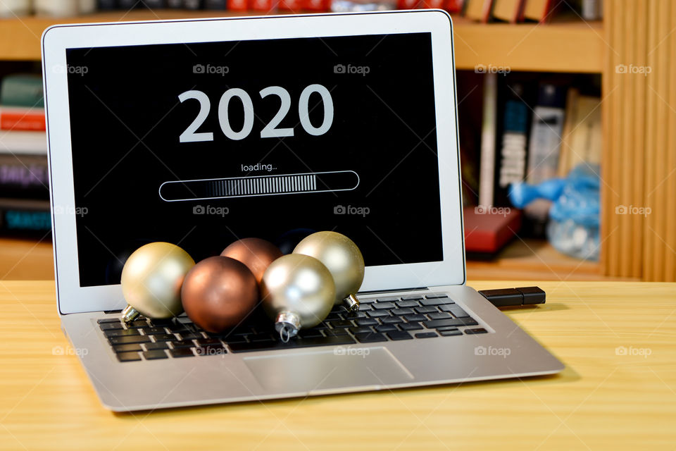 Text - 2020 loading and loading bar on laptop desktop, bookshelf, christmas ball, new year concept