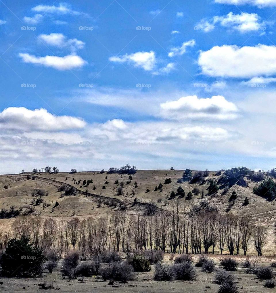 All over of the clouds, sky, mountain, trees, rock are well matched. colors, shape and line are beautiful, this is a beautiful landscape.