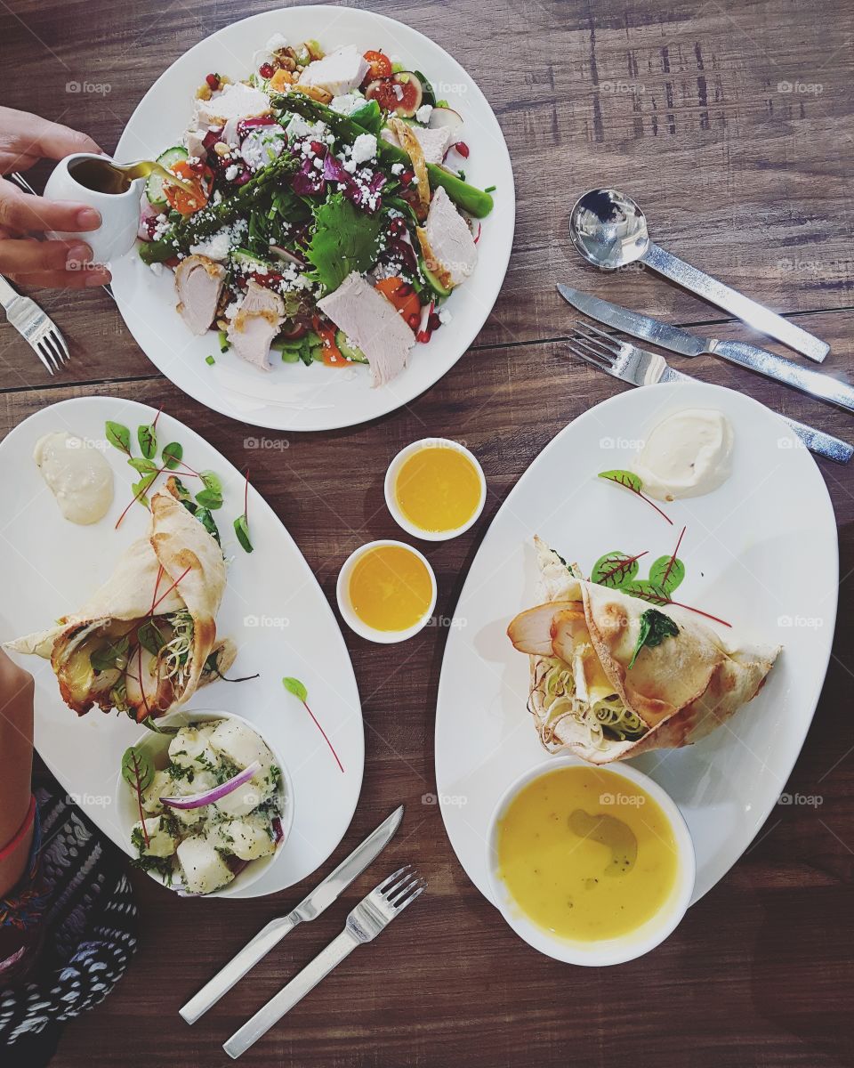 Flatly of three plates of warming, comfort food. Soup, salad and wraps