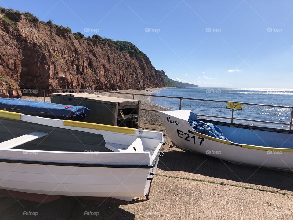 The second of two taking in coast and vessels alike in Sidmouth, Devon, UK