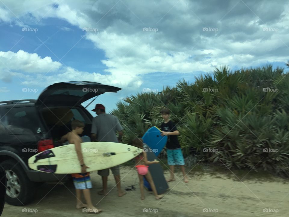Surfers unloading their boards at Flagler Beach, Florida.