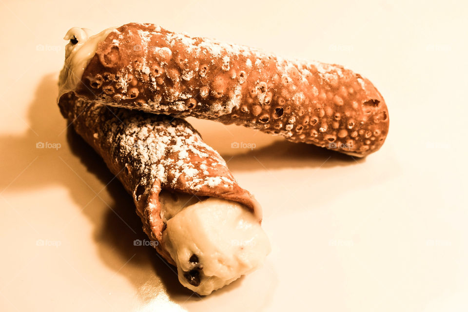 Two Canoli Pastries Stacked Together On White Background