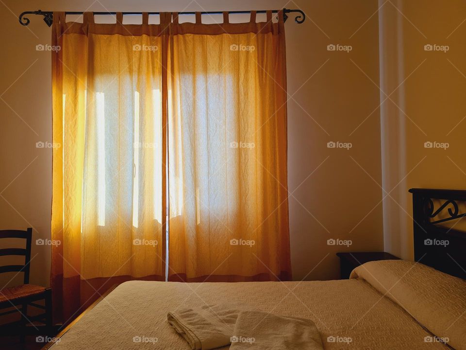 dark corner of bedroom with yellow curtain