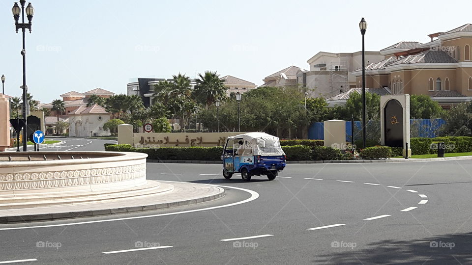Roundabout/ Luxery villa by the Streets and Three wheeler on the street