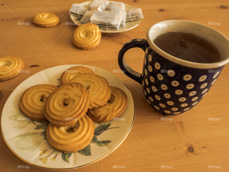 Close-up of teacup with baked biscuit