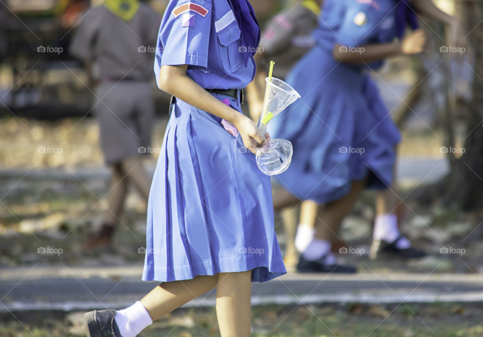 Hand Asean girl holding a glass of waste plastic and Drinking straws colorful.