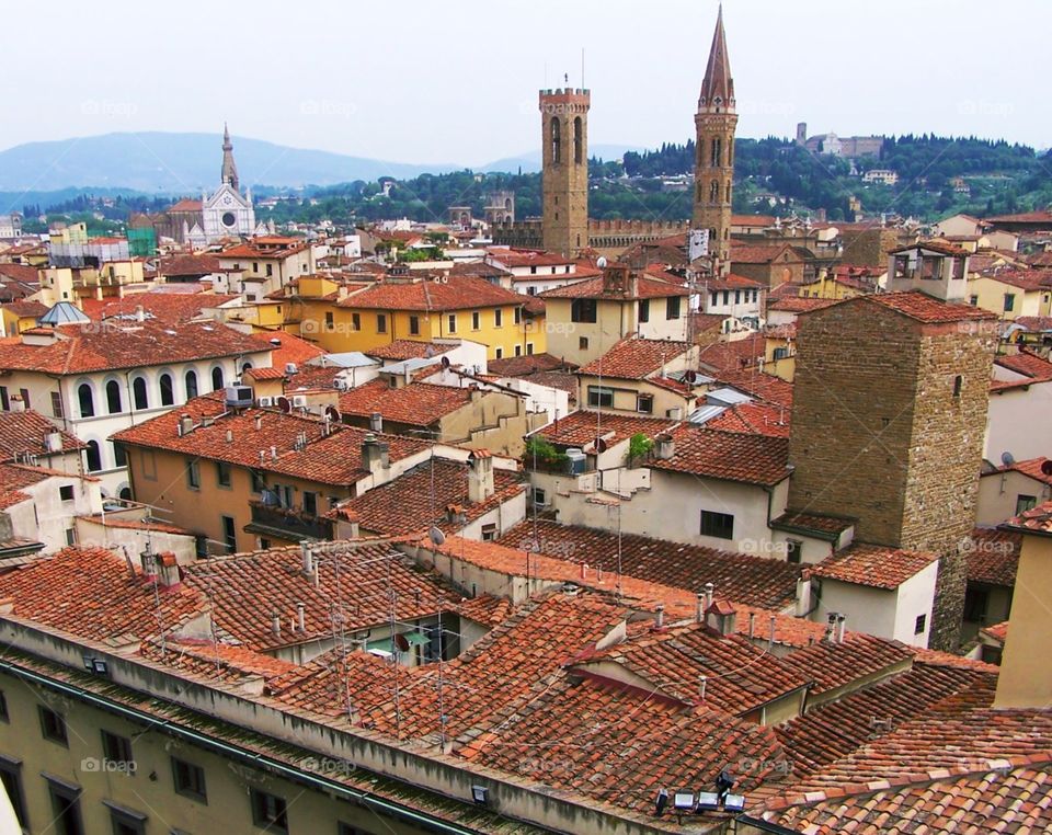 View of rooftops in Florence, Italy, from the Bell Tower; hills of Tuscany and Sante Croce in distance