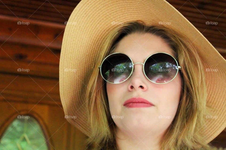 Close-up of young woman in sunhat