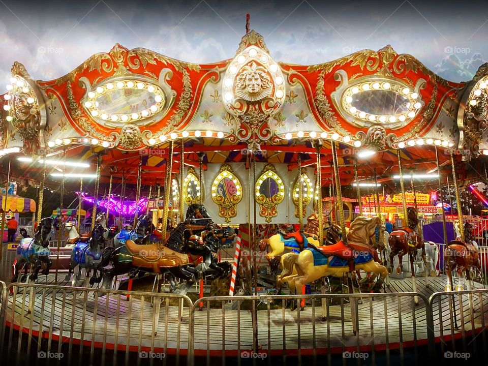 Merry-Go-Round full of horses , light , movement and music.