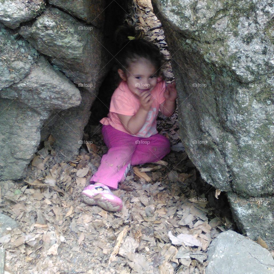 Hiding in the rocks. Hiking at the Purgatory Chasm and my daughter decides to crawl under rocks