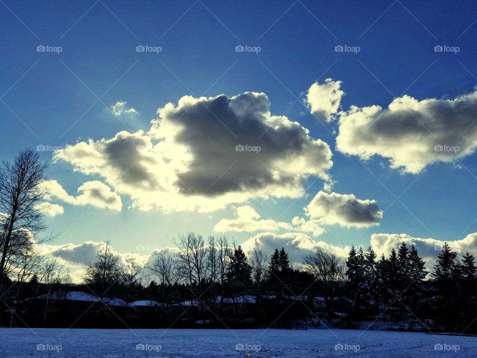 snow and clouds with sun peeking through