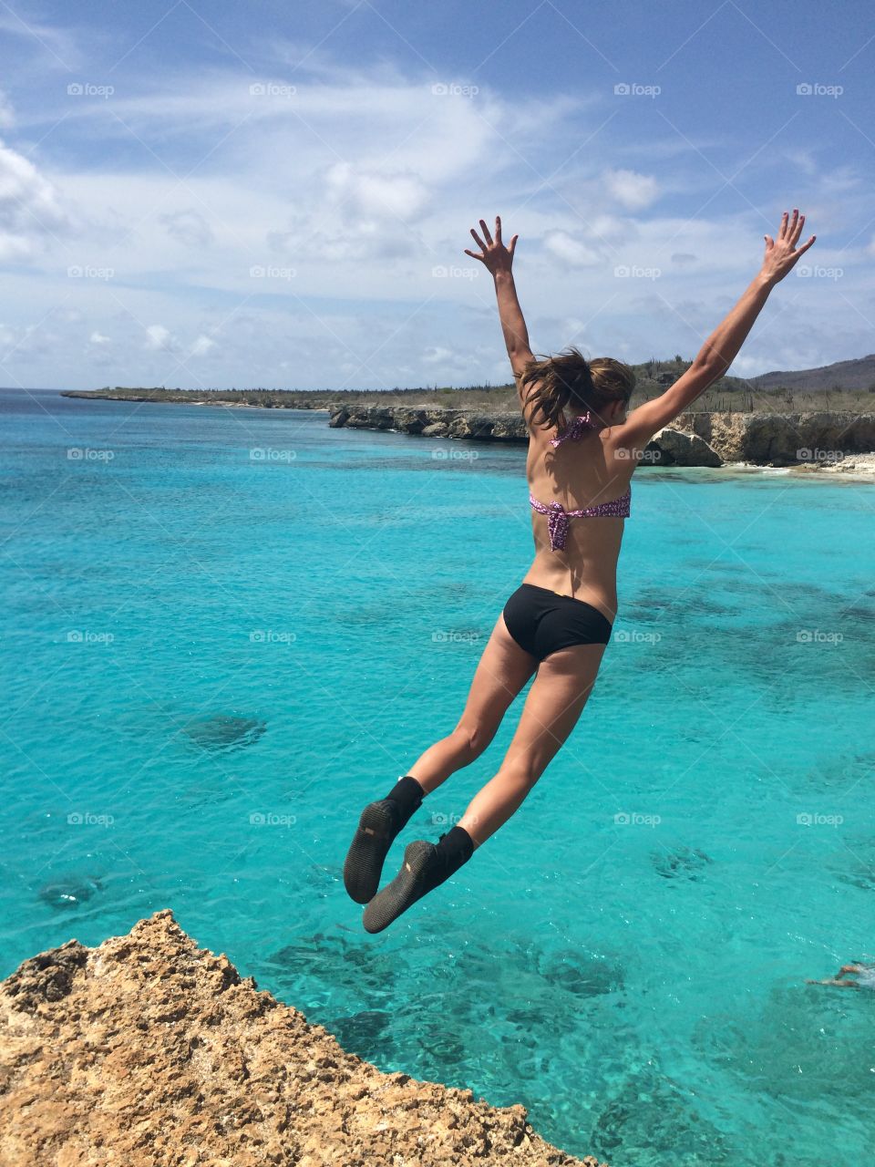 Geronimo! Jumping off a cliff into the beautiful, crystal clear water of Bonaire. 