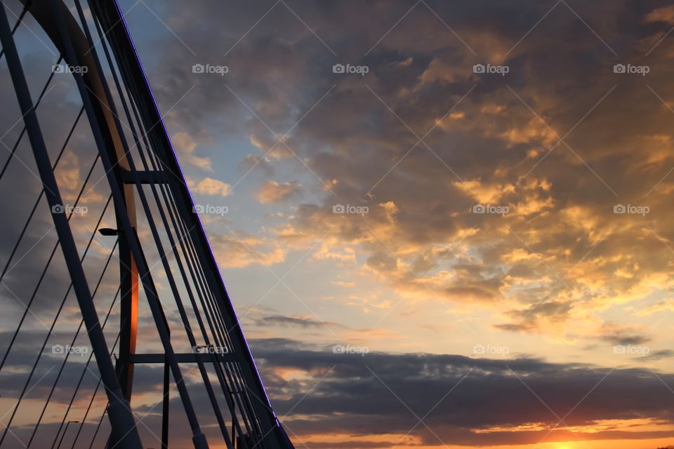 Bridge railing against dramatic sky
