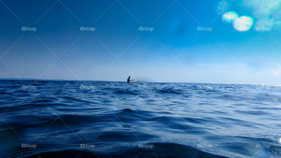 A person kayaking on sea