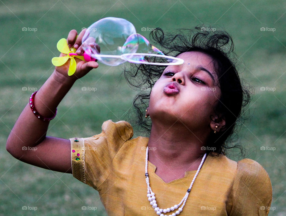 A story of a girl who was enjoying playing with soap bubbles...