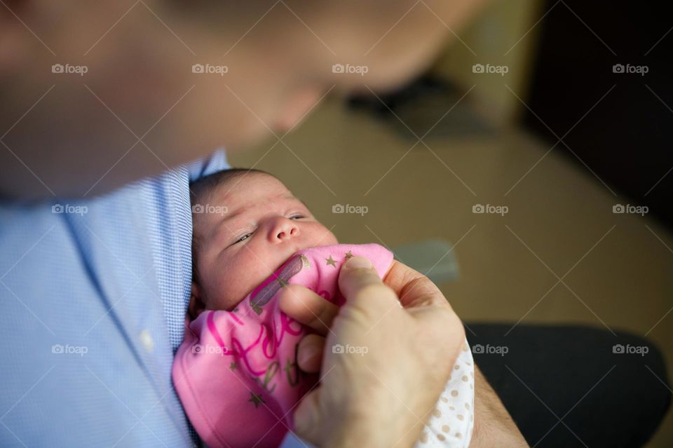 baby in dad's arms