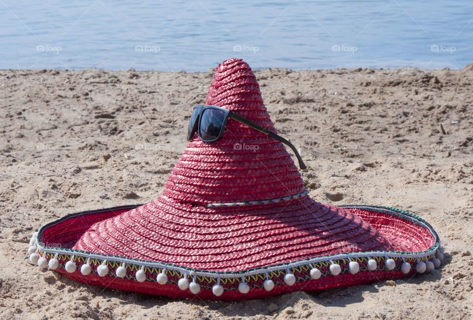 Hat of a sombrero  lies on the beach