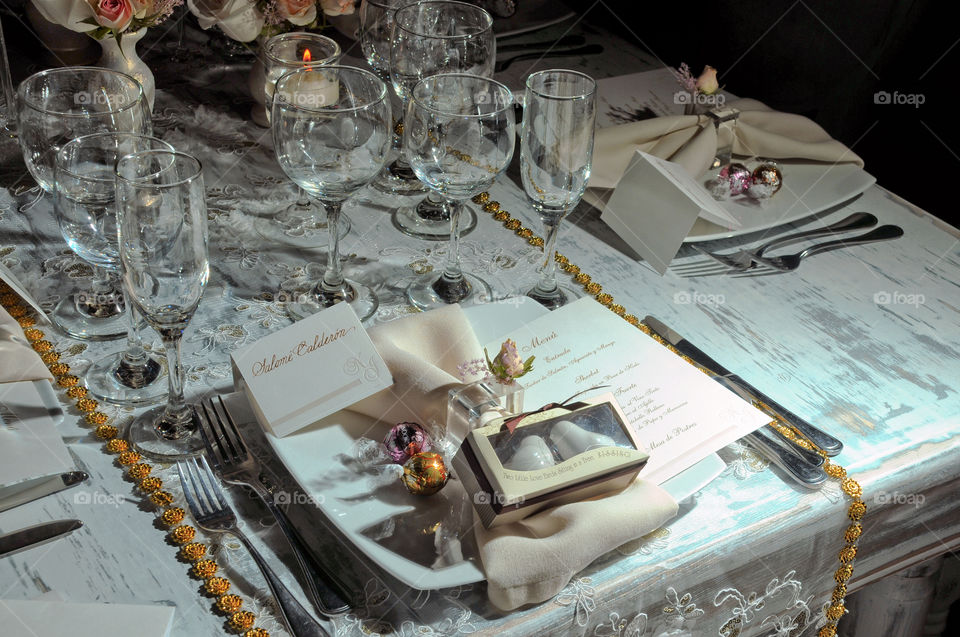 Decorated table with glasses of water glasses and dedications