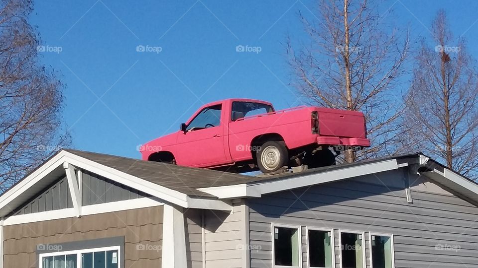 Red truck on a house for some reason.