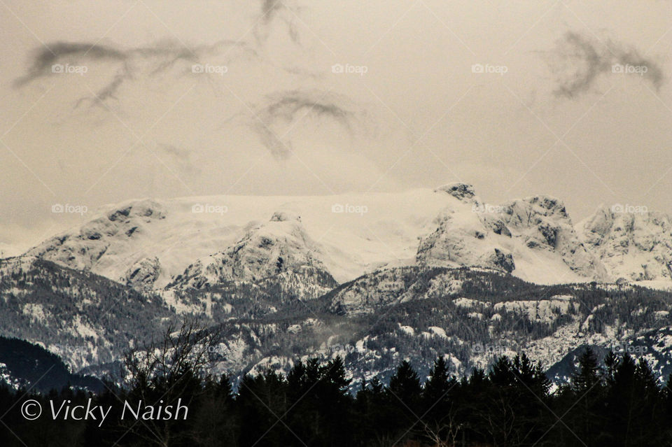 This is a monochrome shot of our local glacier with little dark wisps of cloud in the sky above. The local K'ómoks First Nations revere this glacier as it is from the origin story that trapped Queneesh, the White Whale, frozen high over the valley. 