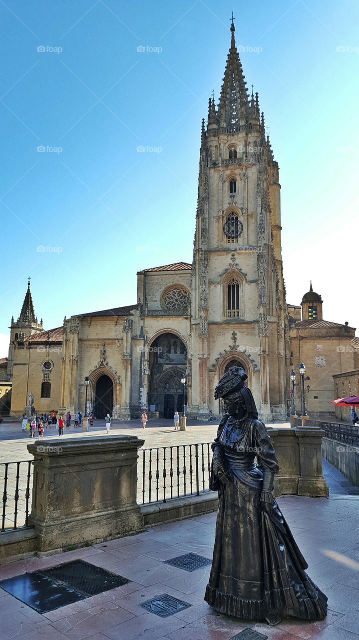 Oviedo cathedral with statue of "La Regenta" in the foreground. Spain.